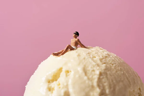 Miniature man in swimsuit on an ice crea — Stock Photo, Image