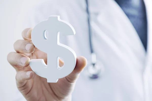 Doctor man with a dollar symbol in his han — Stock Photo, Image