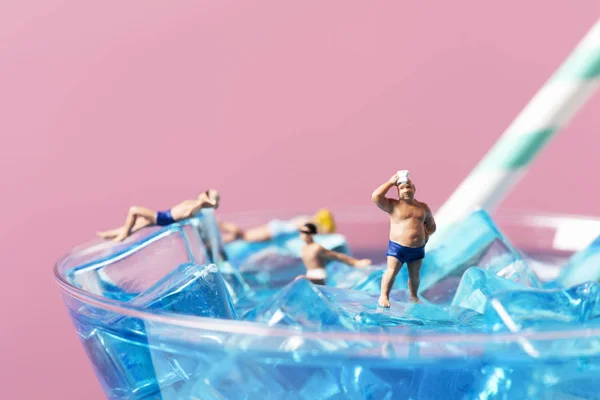 Miniature people in swimsuit on a cocktai Stock Picture