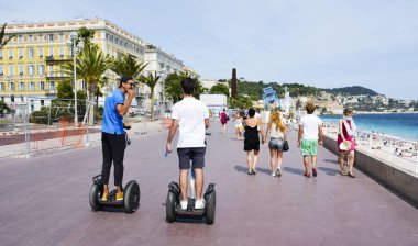Fransa 'nın Nice kentindeki Promenade des Anglais' deki insanlar