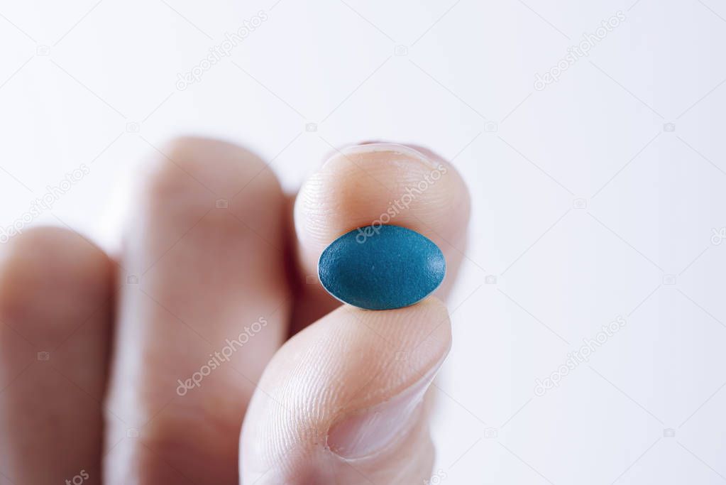 young man with a blue pill