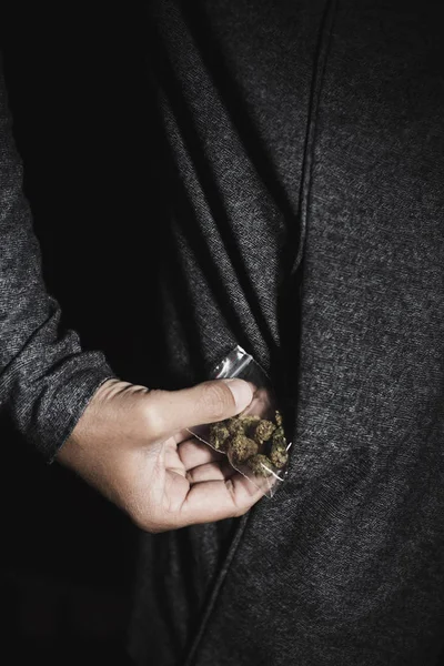 Young man with a bag of marihuana buds — Stock Photo, Image