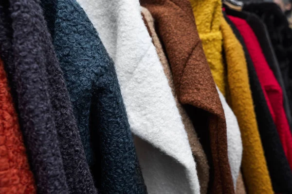 Sweaters hanging on a rack — Stock Photo, Image