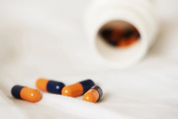 Capsules on an unmade bed — Stock Photo, Image