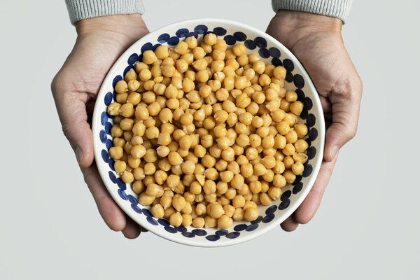 man with a bowl of chickpeas
