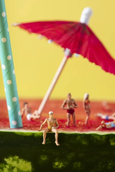 Miniature people in swimsuit on a watermelon — Stock Photo, Image