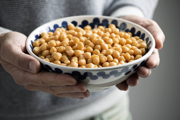 man with a bowl of chickpeas