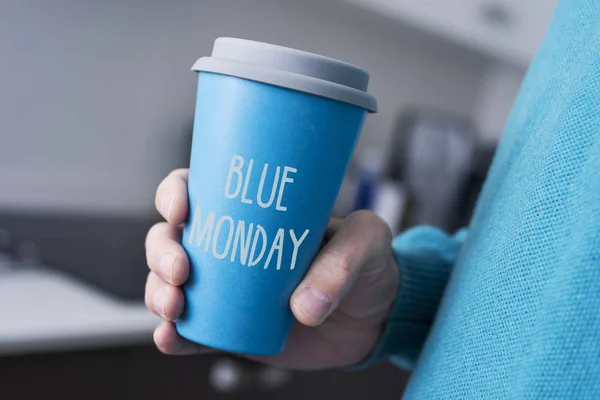 Man and cup of coffee with the text blue monda — Stock Photo, Image