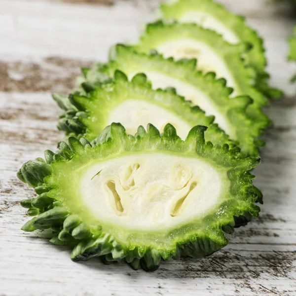 Slices of raw karela on a table — Stock Photo, Image