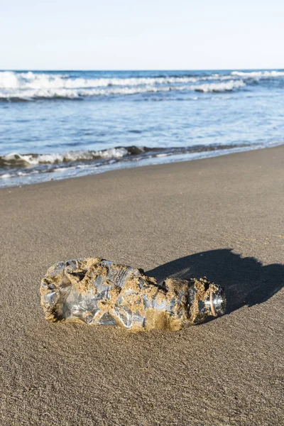 Used plastic bottle on the sand of a beach — Stock Photo, Image