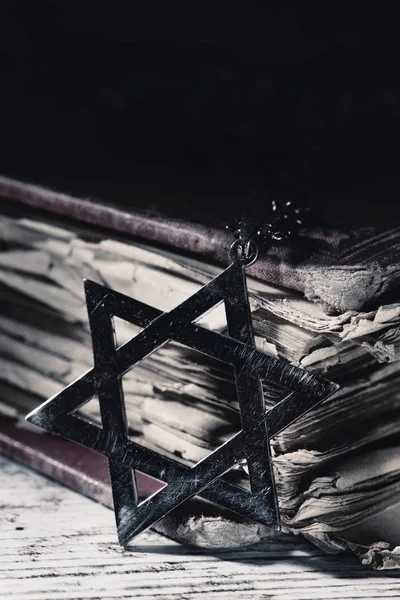 Old book and star of david on a rustic surfac — Stock Photo, Image