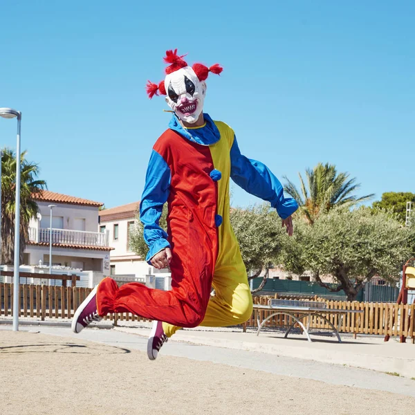 Payaso Aterrador Con Colorido Traje Amarillo Rojo Azul Saltando Parque — Foto de Stock