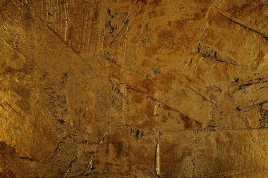 Arkaplan olarak kullanılacak, altın desenli, alçılı bir yüzeye yakın plan