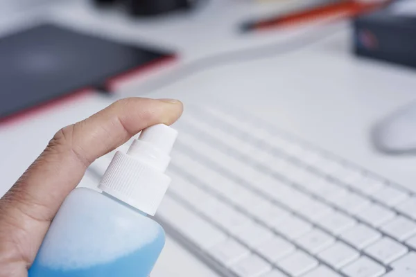 Closeup Caucasian Man Disinfecting Computer Keyboard Spraying Blue Sanitizer Bottle — Stock Photo, Image