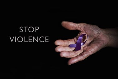 closeup of a senior caucasian woman with a purple ribbon in her hand, for the awareness about the unacceptability of the violence against women, and the text stop violence on a dark background clipart