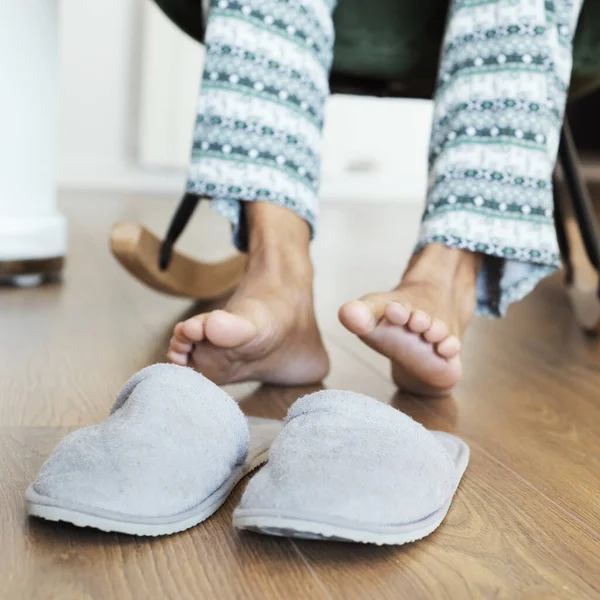 Closeup Man Pajamas Sitting Modern Rocker Put Pair Gray Slippers — Stock Photo, Image