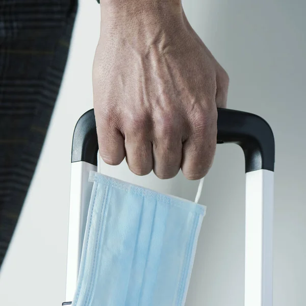 Closeup Young Man Surgical Mask His Hand Pulling Suitcase Its — Stock Photo, Image