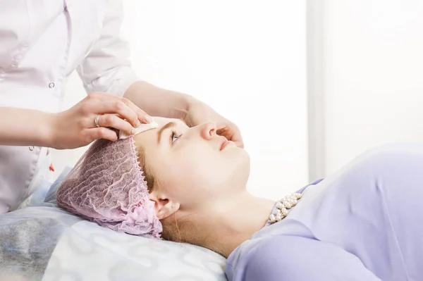 Cleaning face in beauty salon