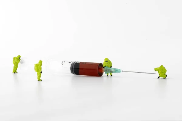 Blood test syringe with small characters on white, closeup