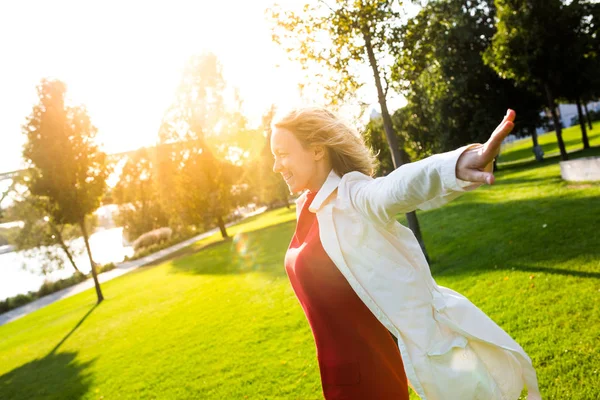 Beautiful happy woman enjoying sunshine and wind outdoors — Stock Photo, Image