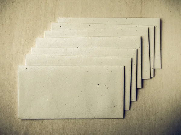 Vintage looking Letter envelope on wood table — Stock Photo, Image