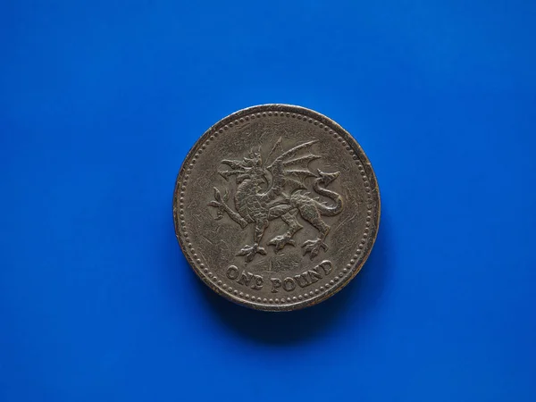 One Pound (GBP) coin, United Kingdom (UK) over blue