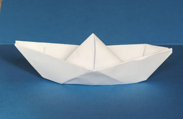Paper boat over blue — Stock Photo, Image
