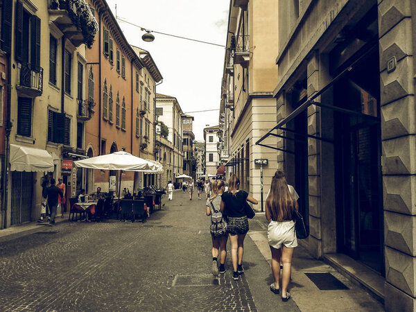 VERONA, ITALY - CIRCA JULY 2016: Vintage desaturated Tourists in Piazza Bra square