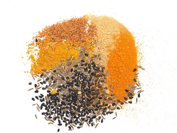 Many spices including Ginger Curry Turmeric Chili pepper Black cumin Nigella sativa over white — Stock Photo, Image