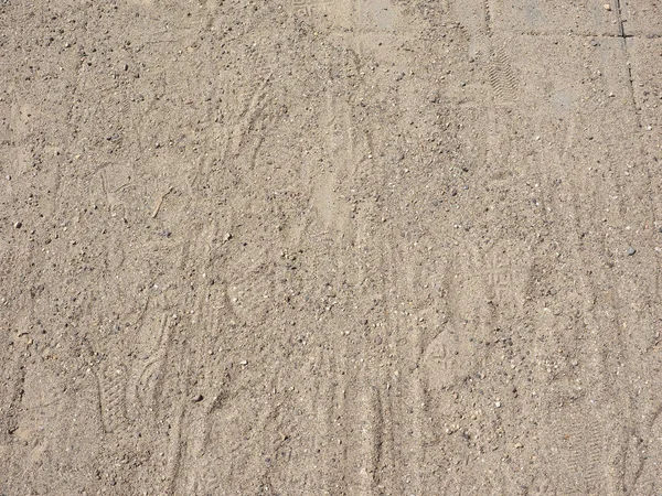 Voetafdrukken in het zand achtergrond — Stockfoto