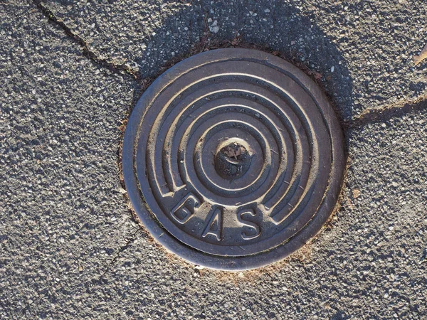 Gas manhole and tarmac — Stockfoto