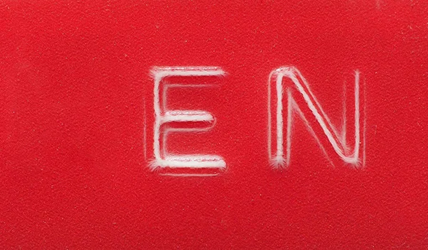 EN (English language) label made with red embossing tape — Stockfoto