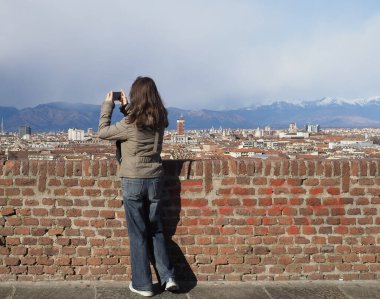 TURIN, ITALY - CIRCA FEBRUARY 2020: Woman looking at the city of Turin from Monte dei Cappuccini on the hill
