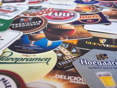 LONDON, UK - MARCH 10, 2020: Beer mats of many different brands clipart