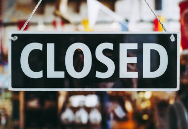 Closed sign in a shop window with reflections clipart