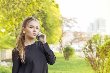 Dışında telefonla aramayı güzel bir genç kadının portresi. metniniz için boş alan