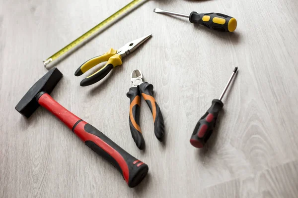 ?ollection of various old hand tools including hammer pliers wrenches and nipper on wooden table background — Stock Photo, Image