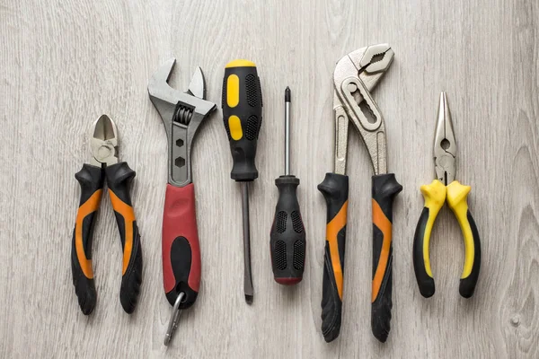 Variety of repair tools on wooden surface — Stock Photo, Image