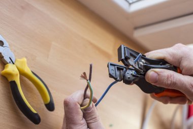 Elektrikçi tel bağlamak için özel araçlar ile keser