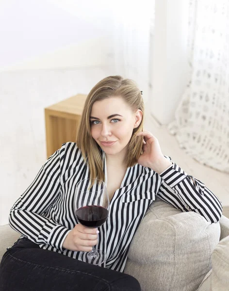 Portrait of happy smiling young attractive woman with glass of red wine, at home — Stock Photo, Image