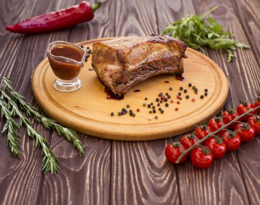 Domuz ateşte pişmiş bir parça sunan restoran. Ahşap arka plan.