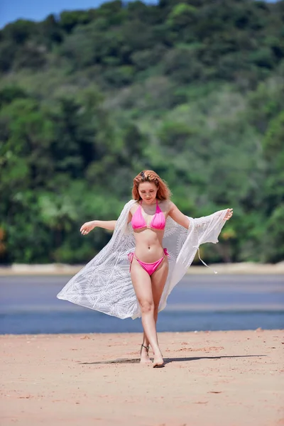 Young asian girl in pink bikini posing at Layan beach, Phuket, Thailand