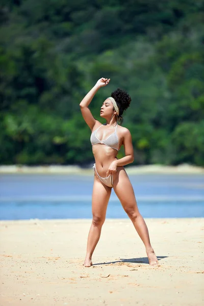 Young asian girl in bikini posing at Layan beach, Phuket, Thailand. Look away