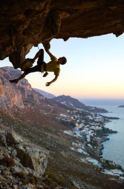 Male rock climber climbing clipart