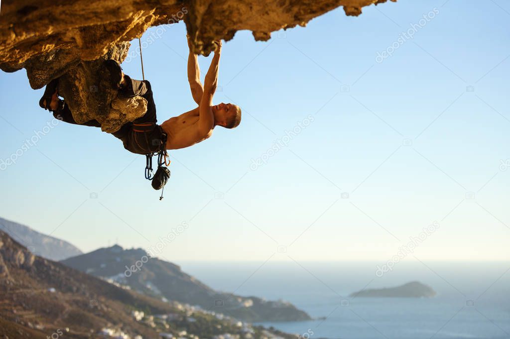 man climbing on roof in cave