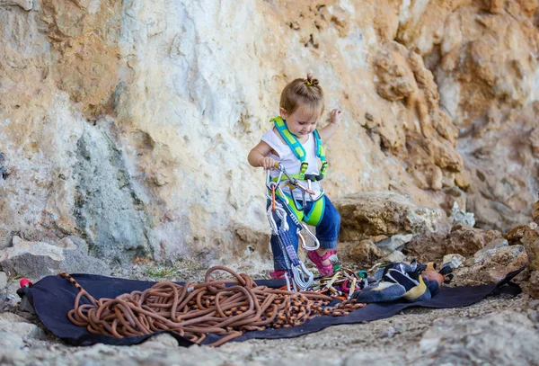 Little girl  playing with rock climbing equipment — Stock Photo, Image