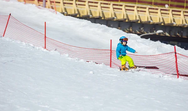 Little boy falling down while skiing in children's area — Stock Photo, Image