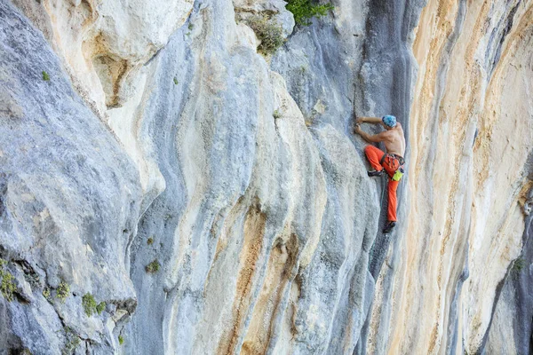 Jonge man klimmen uitdagende route op klif — Stockfoto