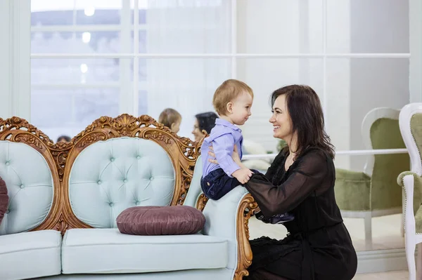 Attractive mature woman and her baby grandson playing at home — 스톡 사진