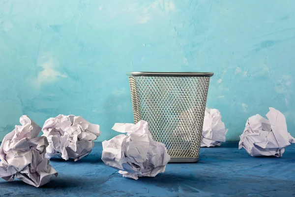 Trash can with scattered papers around. Beautiful background with place for text. Empty bin.